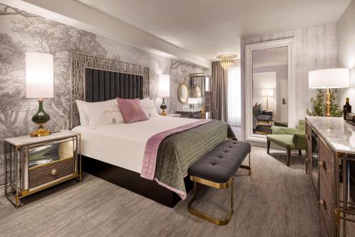 a bedroom with a bed and a table and a chair at The Vanderpump Las Vegas Hotel & Casino - A Caesars Rewards Destination in Las Vegas