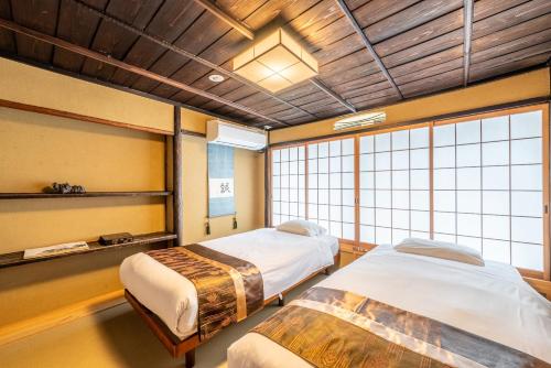a hospital room with two beds and a window at Spacious Kyoto Machiya - Goemon Bath - 4BR in Kyoto
