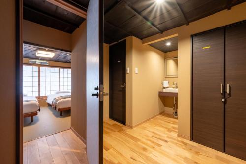 a room with two beds and a bathroom at Spacious Kyoto Machiya - Goemon Bath - 4BR in Kyoto