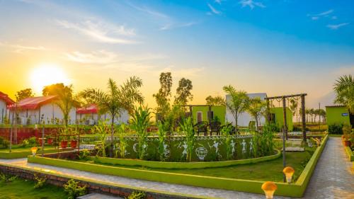 a resort with a garden in front of a building at Sumitel Araku Mount View Camping Resort in Sunkarimetta