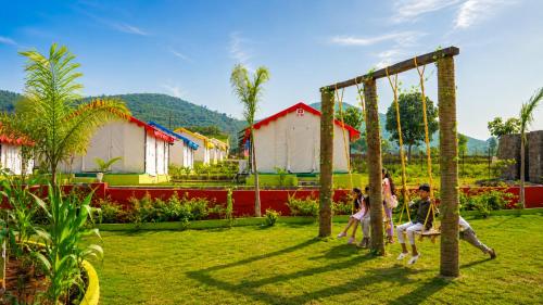 a group of people playing on a swing at Sumitel Araku Mount View Camping Resort in Sunkarimetta