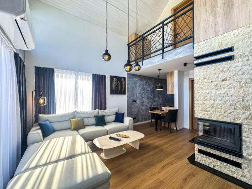a living room with a couch and a fireplace at Lux House in Hadžići