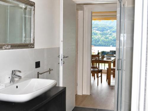 a bathroom with a sink and a dining room at Residence Belvedere by Lago Reisen in Omegna