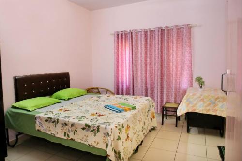a bedroom with a bed and a table and a window at Alleppey La Casa in Alleppey