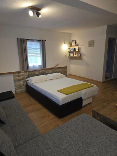 a bedroom with a large bed in a room at Holiday house LUMA in Hrvace
