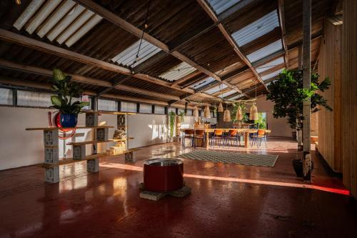 a large room with tables and potted plants in it at Buiteninn in Rijssen
