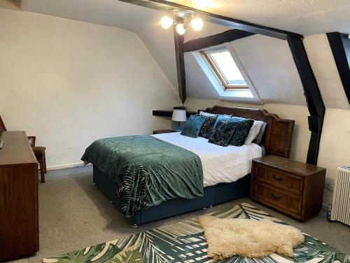 a bedroom with a large bed and a window at 2 Bed Period Flat with parking in Ross on Wye