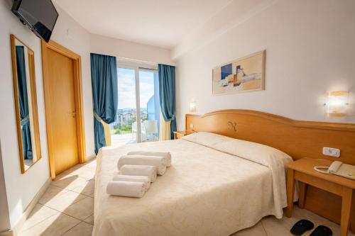 a bedroom with a bed with towels on it at GRAND HOTEL OLIVIER PRINCe in Roseto degli Abruzzi