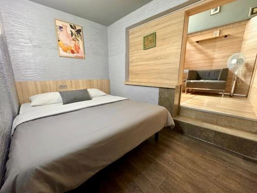 a bedroom with a bed with a mirror and a chair at Mouse House in Chişinău