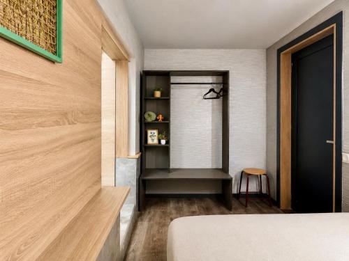a bedroom with a bed and a book shelf at Mouse House in Chişinău