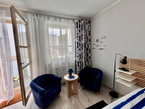 a room with two chairs and a table and a window at Maritime Apartment in Świnoujście