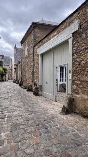 a brick building with a garage on the side of it at Maison Saint Christophe in Le Mans