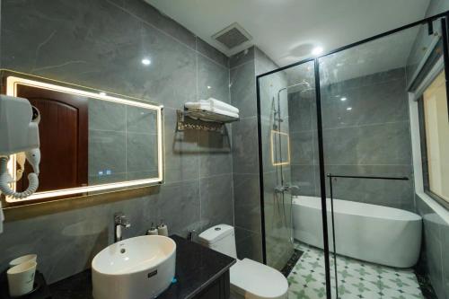 a bathroom with a sink and a toilet and a shower at Olong Pho Co Hotel Ninh Binh in Kỳ Vĩ