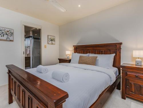 a bedroom with a large bed and two night stands at Breakwater Views Apartment 2 Cabarita Beach in Cabarita Beach