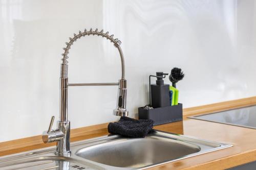a kitchen sink with a metal faucet at Ferienwohnung Ostermann in Plettenberg