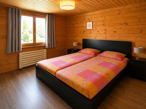 a bedroom with a bed in a wooden room at Chalet in Wiler near Ski Lift & Views in Fiesch