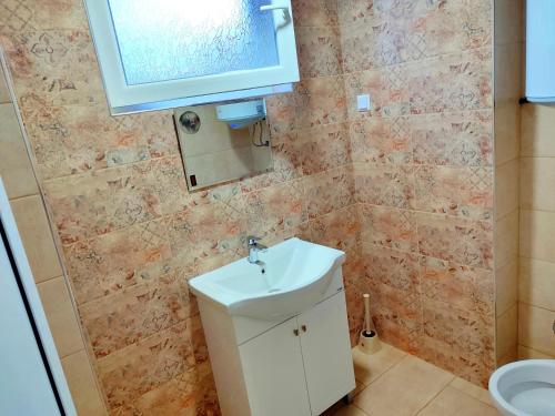 a small bathroom with a sink and a toilet at Goranovi House in Pleven
