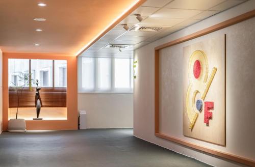 a room with a picture of a instrument on the wall at 休日行旅 Vacay Stay in Tainan