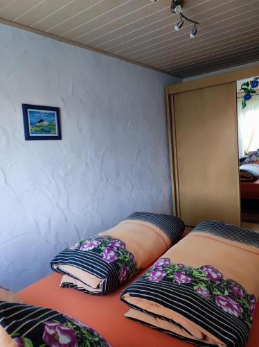 two beds in a room with pillows on them at Ferienwohnung Waldblick in Langenfeld