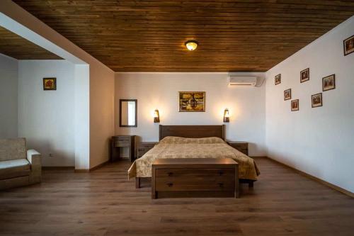 a bedroom with a bed and a chair in it at Комплекс Стара Плиска in Pliska