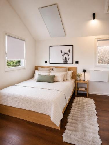 a bedroom with a large bed and two windows at Aktivurlaub im Schwarzwald Natur Sport und Erholung in Efringen-Kirchen