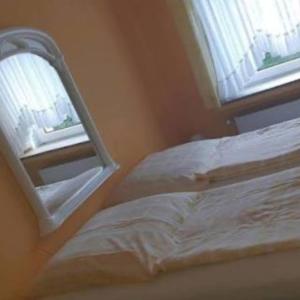a bedroom with a mirror next to a bed at Hotel zur Rennvahn in Dortmund