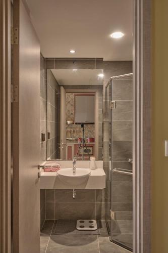 a bathroom with a sink and a shower at LangX Ecopark Sky Forest - Dolce Apartment in Kim Quan