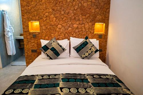 a bedroom with a bed with pillows on it at Nyota Boutique Hotel Zanzibar in Nungwi