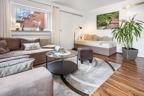 a living room with a couch and a table at Ferienglück Vogelsang in Loßburg