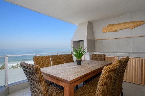 ein Esszimmer mit Tisch und Stühlen und dem Meer in der Unterkunft St Daniel 8, Ramsgate in Ramsgate