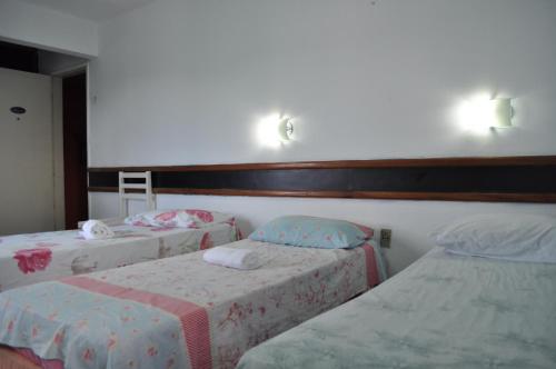 two beds in a room with two at CP Hotel Economic in Natal