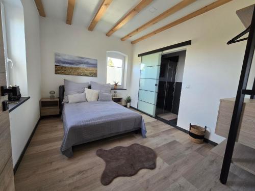 a bedroom with a bed and a large window at Scheuneria, Gästehaus in Dockweiler