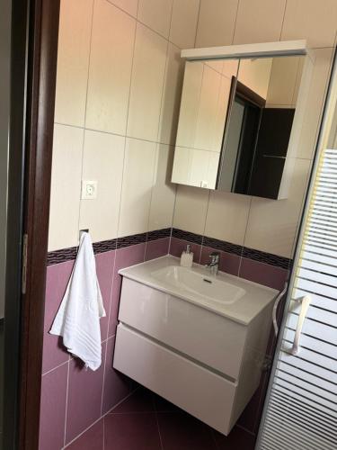 a bathroom with a sink and a mirror at Apartment Ćule in Senj