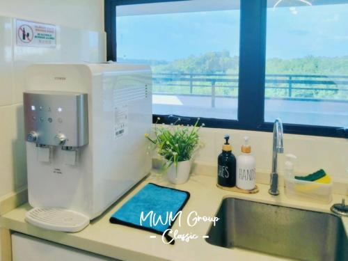 a kitchen counter with a mixer and a sink at Signature Mutiara Beach Resort by MW in Malacca
