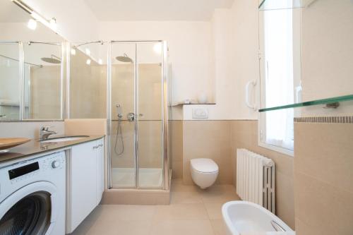 a bathroom with a shower and a toilet and a sink at Simo House Stunning Lake View Balcony AC in Carate Urio