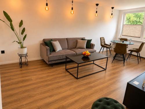 a living room with a couch and a table at Baltijos Apartamentai, Self check-in, free parking in Klaipėda