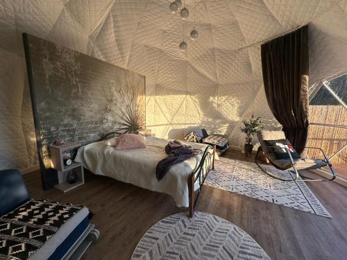a bedroom with a bed and a wall with a net at Saare Glamping Dome House in Salme
