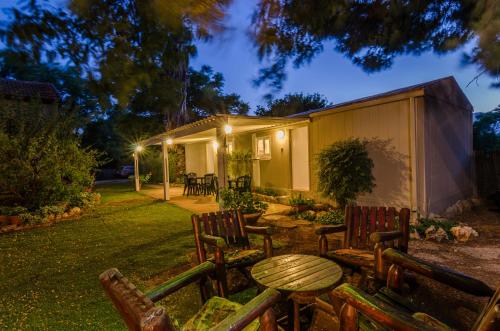 a group of chairs and a table in front of a building at Orna's Corner in Yuval