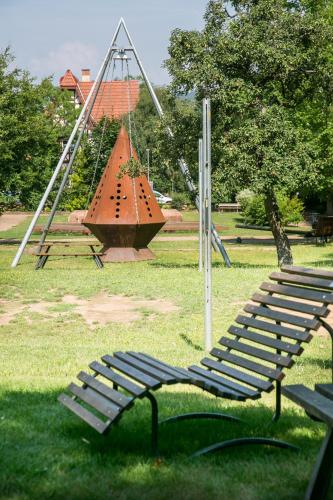 a bench in a park with a swing at Jugendhaus St. Kilian in Miltenberg