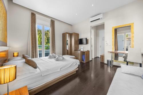 a bedroom with a large bed and a living room at Modern Rooms Villa Oasiss by Istrabook in Pula
