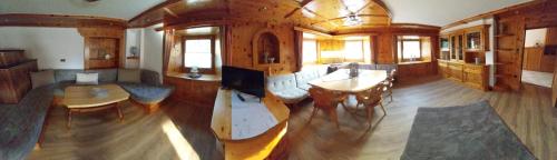 a large living room with a table and chairs at Thalerhof-Markus in Roppen
