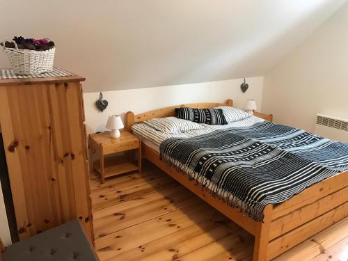 a bedroom with a bed and a wooden floor at Villa Tourmaline in Kremnica
