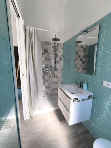 a bathroom with a sink and a shower at New Casa bluchic in Isola delle Femmine