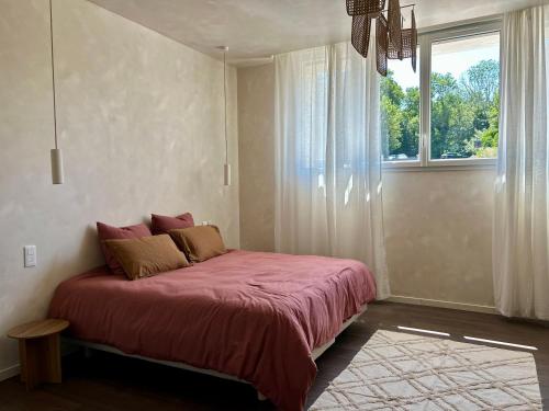a bedroom with a red bed with a window at Bulle de détente - Proche Disney in Villiers-sur-Morin