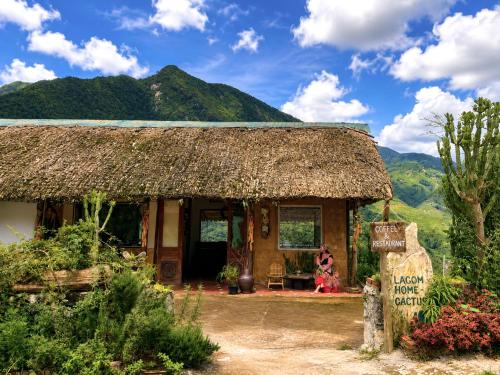 a small house with a thatched roof and a sign at Lagom home - Cactus in Sapa