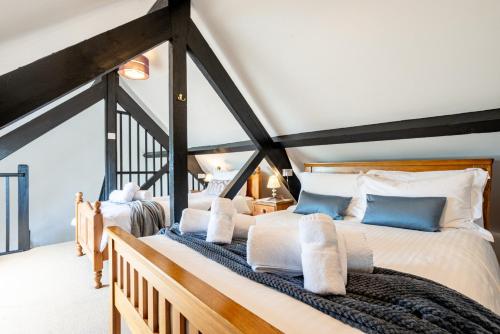 two beds in a room with a attic at Duchy - Treworgie Barton Cottages in Bude