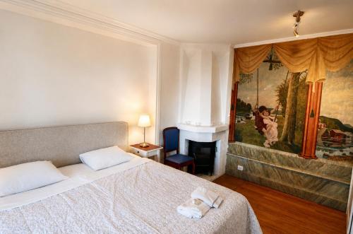 a bedroom with a bed and a painting on the wall at Husby Wärdshus in Dala Husby