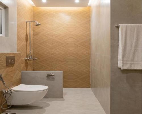 a bathroom with a white toilet and a shower at Hotel Mashabrum Skardu Free Breakfast Mountain View Family Rooms & Free WiFi in Skardu