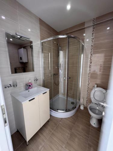 a bathroom with a shower and a sink and a toilet at SunsetEscape Apartments Utjeha in Utjeha