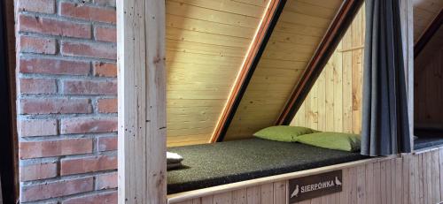 a sauna with two green pillows in a brick wall at Folwark Pod Bukowcem in Podzamcze